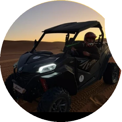 Dune buggy in the desert at sunset